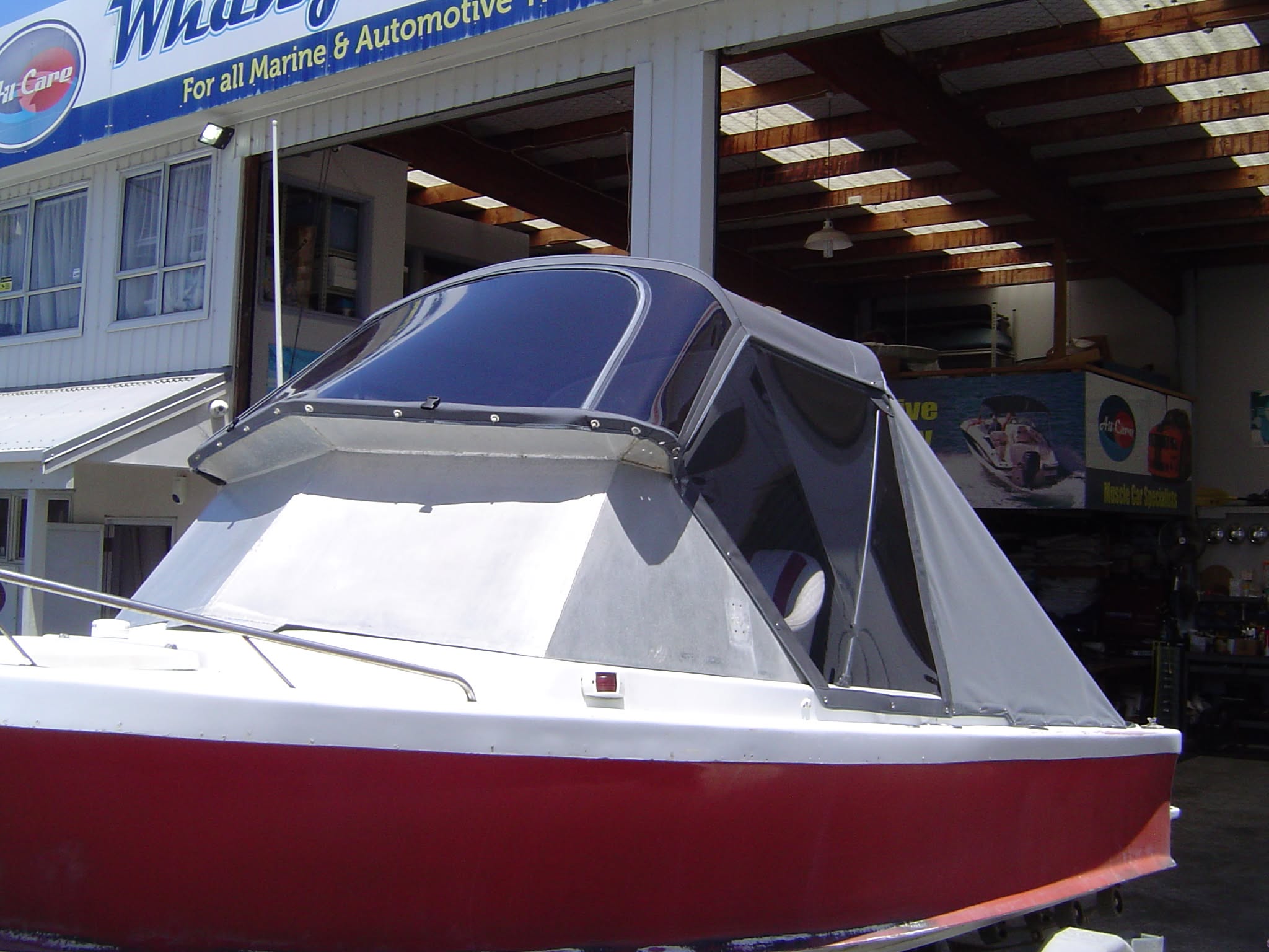 Grey canopy on a red hull